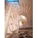 Винтовая лестница из мрамора с коваными перилами 
